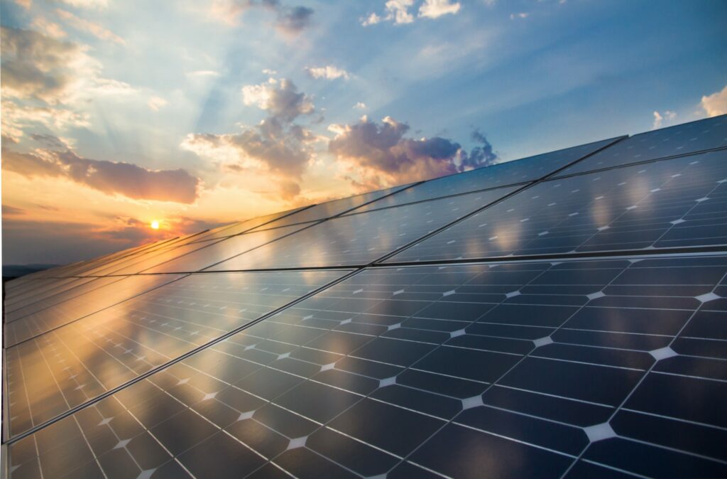 Solar panels facing the sky with light reflecting off