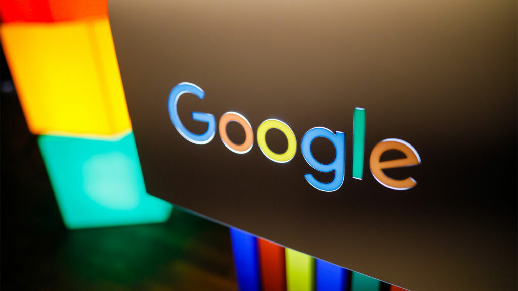 Google logo on black background with colourful lighting