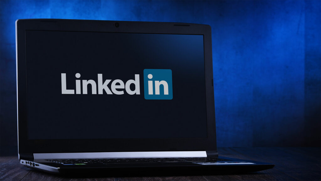 Laptop with LinkedIn logo across the screen