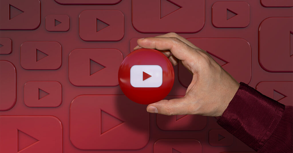 Person holding YouTube play button