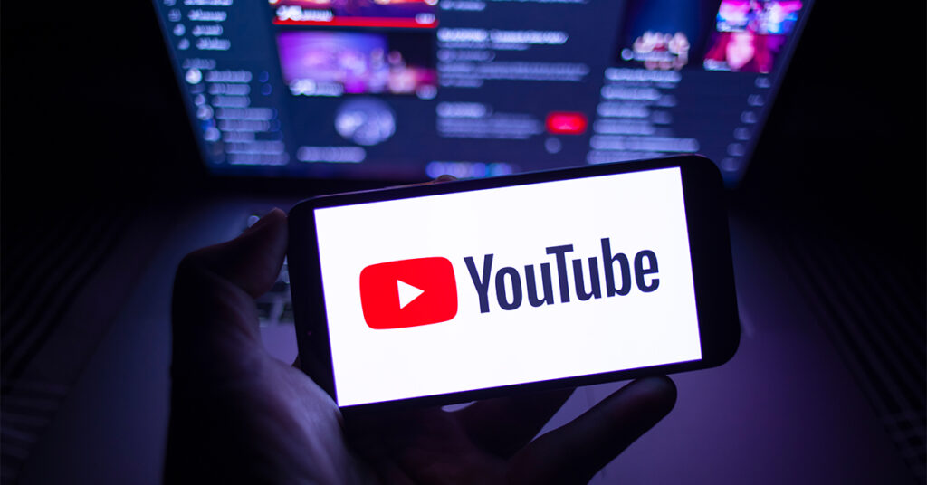 YouTube logo on smartphone as well as computer