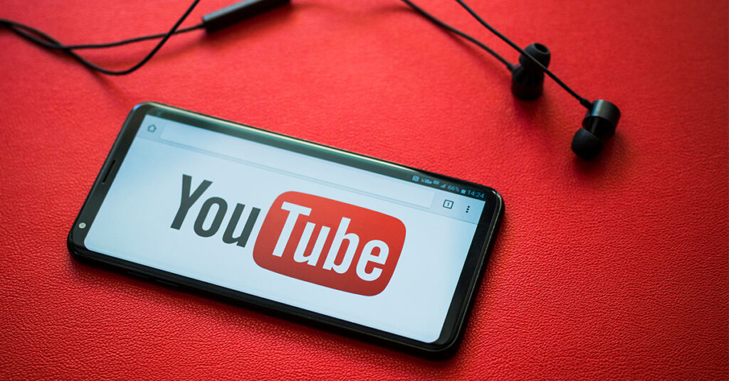 smartphone with YouTube logo and red background