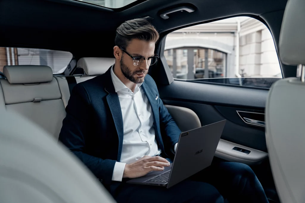 Man sitting in car using ExpertBook B9 OLED